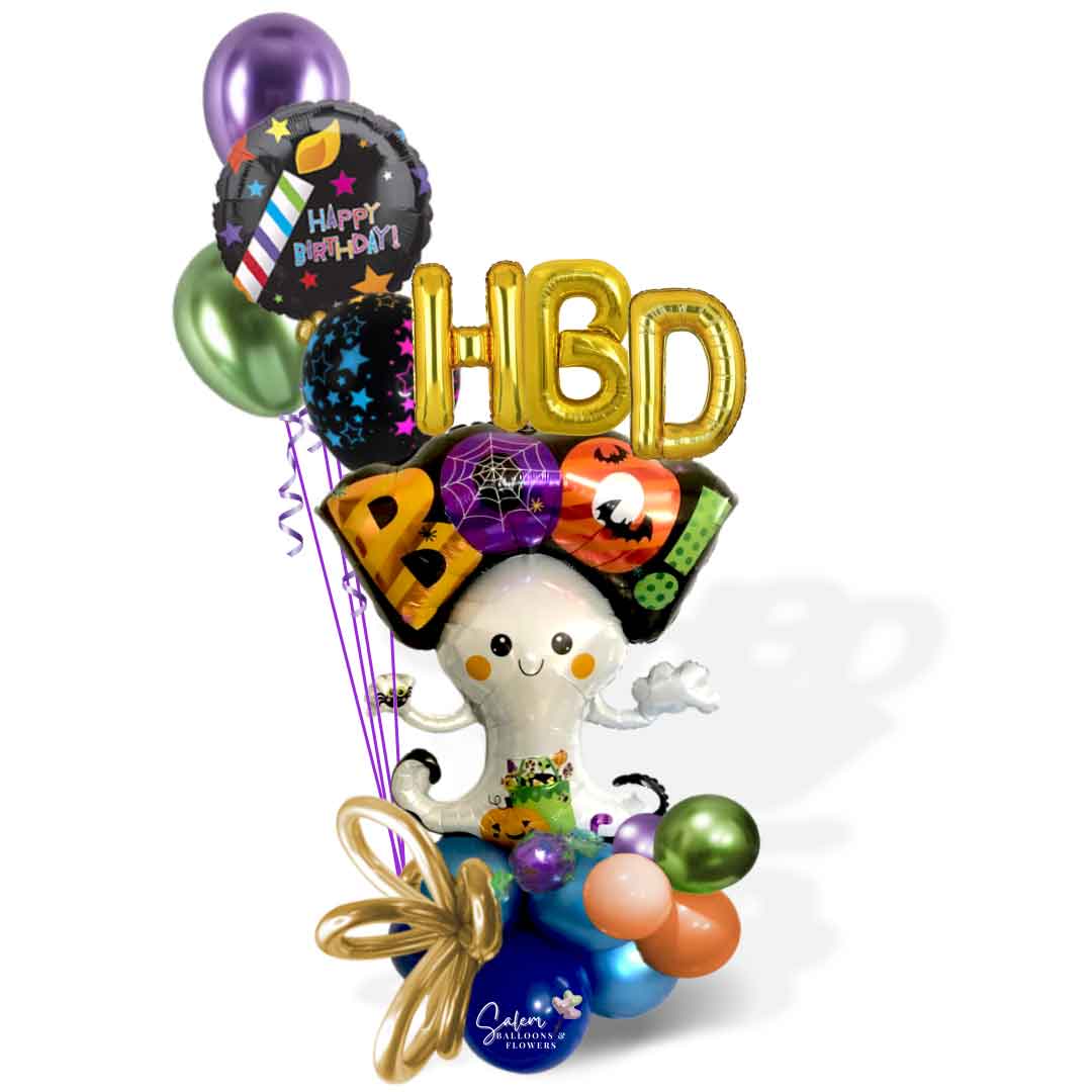 A Halloween-themed birthday bouquet featuring a large ghost balloon carrying an "HBD Boo" sign, floating over a colorful balloon cloud and a bouquet of helium balloons. Balloon Salem Oregon.